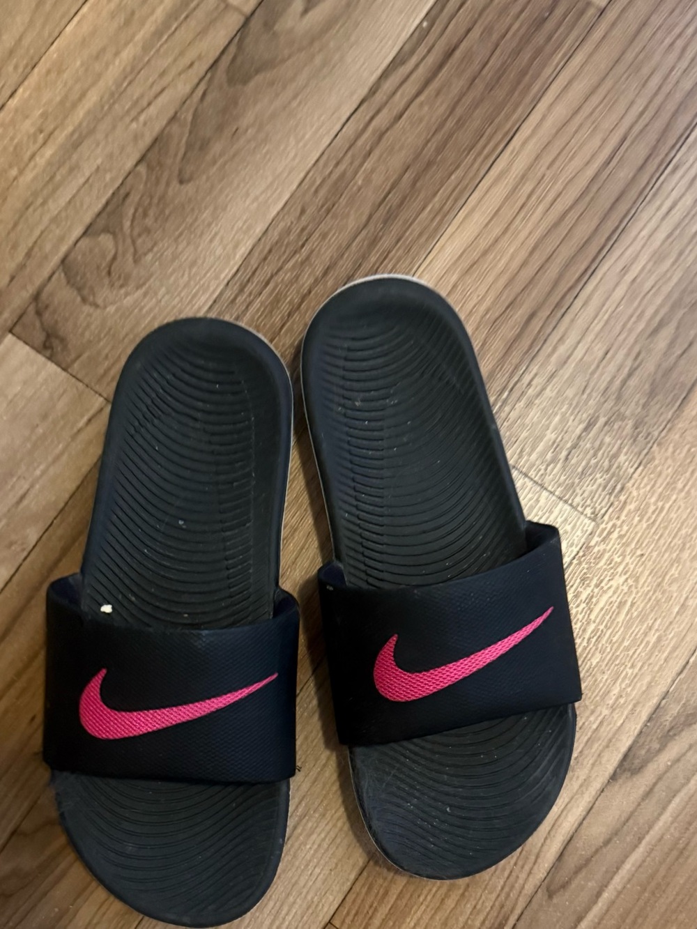 Nike Black Slides with Pink Swoosh Accent